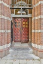 a pair of red doors on a brick building