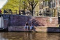 Amsterdam, Netherlands - April 15, 2015: cityscape with typical canal in Amsterdam, with unidentified people. Amsterdam is the