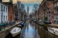 AMSTERDAM, NETHERLANDS - APRIL 10, 2018: Amsterdam cityscape with Zuiderkerk church South Church view from the Groenburgwal cana