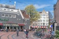 Amsterdam, Netherlands - April 09, 2019: Classic bicycles and historical houses in old Amsterdam. Typical street in Amsterdam with