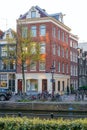 Amsterdam, Netherlands - April 09, 2019: Classic bicycles and historical houses in old Amsterdam. Typical street in Amsterdam with
