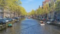 Amsterdam, Netherlands - April 09, 2019: Classic bicycles and historical houses in old Amsterdam. Typical street in Amsterdam with