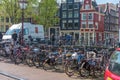 Amsterdam, Netherlands - April 09, 2019: Classic bicycles and historical houses in old Amsterdam. Typical street in Amsterdam with