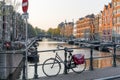 Amsterdam, Netherlands - April 09, 2019: Classic bicycles and historical houses in old Amsterdam. Typical street in Amsterdam with