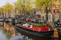 AMSTERDAM, NETHERLANDS - April 2, 2019: Colorful flower shop in boat on water channel