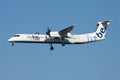 Flybe Bombardier DHC-8 Q400 G-JECZ passenger plane arrival and landing at Amsterdam Schipol Airport Royalty Free Stock Photo