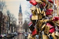 AMSTERDAM, NETHERLANDS - APRIL 10, 2018: Hundreds of padlocks called love locks in Amsterdam, Netherlands. Locks left as promise