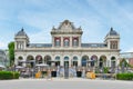 the facade of a building with tables and chairs outside Royalty Free Stock Photo