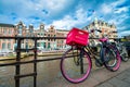 AMSTERDAM, THE NETHERLANDS - APRIL 25, 2015: The life of canals and streets. Bikes parked along the bridge