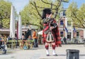 Amsterdam , Netherlands - April 31, 2017 : Scottish bagpiper tuning his instrument in the streets of Amsterdam wearing