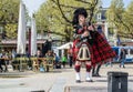 Amsterdam , Netherlands - April 31, 2017 : Scottish bagpiper tuning his instrument in the streets of Amsterdam wearing
