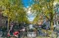 Small quiet canal with bikes on bridge in front in the Center of Amsterdam Royalty Free Stock Photo