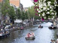 beautiful white and violet flowers with amstel river touristic scene at background Royalty Free Stock Photo