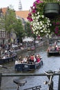 Famous amstel river canal touristic scene with sprin flowers and tourist