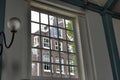 Amsterdam, the Netherlands. August 2019. Seen from inside the church of the city beguinage, through a large window one recognizes