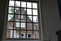 Amsterdam, the Netherlands. August 2019. Seen from inside the church of the city beguinage, through a large window one recognizes