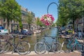 Bridge over canal with bicycles and flowers, Amsterdam, the Nethelands