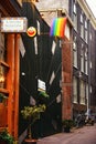 Amsterdam, Netherlands - 09/15/2019: Beautiful little traditional houses and THE WEB institution with the LGBT symbol