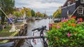 Amsterdam, Netherlands - 15.10.2019: Bicycles on a bridge over the canals of Amsterdam. Colorful houses and flowers. Autumn Royalty Free Stock Photo