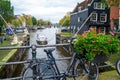 Amsterdam, Netherlands - 15.10.2019: Bicycles on a bridge over the canals of Amsterdam. Colorful houses and flowers. Autumn Royalty Free Stock Photo