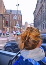 Amsterdam Netherlands. Blonde woman inside tram looks at cityscape. Transportation, travel and tourism concept