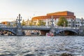 Amsterdam, Netherlands, 08/22/2015: Canal with a brick arch in the city