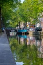 Amsterdam, Netherlands - 06/14/2019: canal with bridge and boats in Amsterdam, Netherlands. Traditional dutch cityscape.