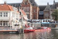 Canal tour boats moored and waiting for passengers. Urban landscape and historic building