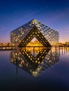 Amsterdam, Netherlands. A cityscape during sunset. A apartment building near the water in the bay.