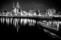 AMSTERDAM, NETHERLANDS - DECEMBER 14, 2015: Black-white photo of cruise boat moving on night canals of Amsterdam Royalty Free Stock Photo