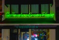 Amsterdam, Netherlands - December 14, 2017: The green neon coffee shop sign.