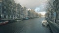 AMSTERDAM, THE NETHERLANDS - DECEMBER 25, 2017. Typical canal and houses alongside embankment Royalty Free Stock Photo