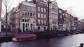 AMSTERDAM, THE NETHERLANDS - DECEMBER 25, 2017. Typical city canal embankment and the Dutch houses facades Royalty Free Stock Photo