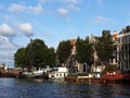 Houseboats, and beautiful traditional houses along canal in the city center of Amsterdam, the Netherlands Royalty Free Stock Photo