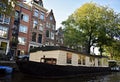 Houseboats, and beautiful traditional houses along canal in the city center of Amsterdam, the Netherlands Royalty Free Stock Photo