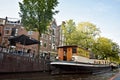 Houseboats, and beautiful traditional houses along canal in the city center of Amsterdam, the Netherlands Royalty Free Stock Photo