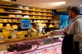 Amsterdam, Netherlands, Europe, October 11, 2019. An unknown person buys cheese at the Amsterdam cheese shop in Holland. Various Royalty Free Stock Photo