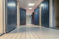 AMSTERDAM/NETHERLANDS-FEBRUARY 24: An empty corridor of a prison with tiles on the floor and open steel cell doors on which texts