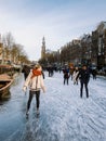 Amsterdam Netherlands, frozen canals and people ice skating in Amsterdam