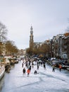 Amsterdam Netherlands, frozen canals and people ice skating in Amsterdam