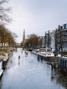 Amsterdam Netherlands, frozen canals and people ice skating in Amsterdam