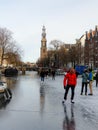 Amsterdam Netherlands, frozen canals and people ice skating in Amsterdam