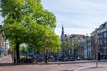 Amsterdam Netherlands Holland. Bike parked on a canal bridge, traditional houses and paved streets Royalty Free Stock Photo