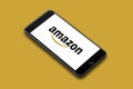 Amsterdam, The Netherlands, 08/18/2019, iPhone 8 plus smart phone lies on a flat colored surface. amazon corporated logo o