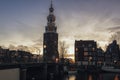 View on the canal Oudeschans at Sunset with the tower Montelbaanstoren in the background in Amsterdam