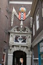 Arched door in ancient red brick building. Coat of arms of the c