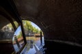 Excursion on a pleasure boat through the canals of Amsterdam, swimming under the bridge Royalty Free Stock Photo