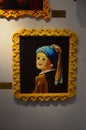 AMSTERDAM, NETHERLANDS - JULY 16, 2022: Girl with a Pearl Earring by Johannes Vermeer made of colorful Lego constructor on white