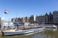 Jetty with pleasure ships on Damrak street in the center of Amsterdam