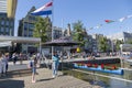 Jetty with pleasure ships on Damrak street in the center of Amsterdam